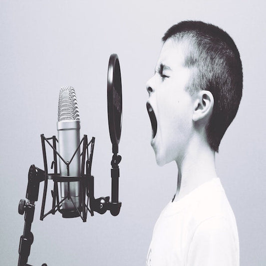 Little kid yelling into a studio microphone.